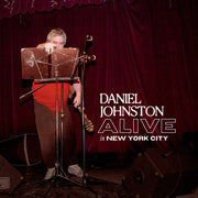 the album cover for Daniel Johnston - Alive In New York City - White [Colored Vinyl] (Wht)