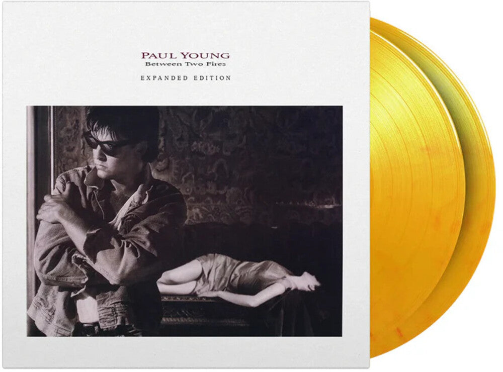 the album cover for Paul Young - Between Two Fires [Colored Vinyl] [Limited Edition] [180 Gram] (Org) (Exp)