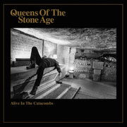 the album cover for Queens Of The Stone Age - Alive In The Catacombs